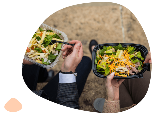 Two persons eating salad